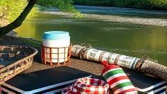 functional CT camping items, content, organizing, photorealistic, beside a tranquil riverbed, highly detailed, reflection on water, 8k resolution, crisp whites and rich greens, afternoon sunbeams, shot with an 85mm lens.